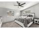 Cozy bedroom features a large bed, two windows, neutral colors, and comfortable carpeting at 7011 W Carol Ann Way, Peoria, AZ 85382