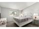 Well-lit bedroom with a wrought-iron bed frame, plush carpeting, and a large window at 7011 W Carol Ann Way, Peoria, AZ 85382