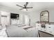 Spacious bedroom features a large bed, mounted television, and abundant storage options at 7011 W Carol Ann Way, Peoria, AZ 85382