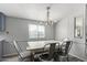 Cozy dining room featuring a rustic table with seating for four and a stylish chandelier at 7011 W Carol Ann Way, Peoria, AZ 85382