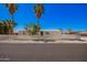 Charming single-story home with a white picket fence and mature trees, perfect for relaxed living at 7011 W Carol Ann Way, Peoria, AZ 85382