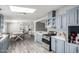 Bright kitchen features blue cabinets, stainless steel appliances, and an adjacent dining area with ample natural light at 7011 W Carol Ann Way, Peoria, AZ 85382