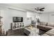 Spacious living room with stylish decor, a comfortable sectional sofa, and modern entertainment setup at 7011 W Carol Ann Way, Peoria, AZ 85382