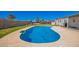 An inviting in-ground pool glistens in a backyard, with lounge chairs for relaxation by the clear water at 7011 W Carol Ann Way, Peoria, AZ 85382