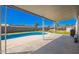 A refreshing pool is surrounded by a concrete patio under a large shaded awning at 7011 W Carol Ann Way, Peoria, AZ 85382