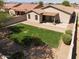 Aerial view of a well-maintained backyard with lush lawn and a covered patio at 7111 S 21St Dr, Phoenix, AZ 85041