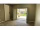 Bedroom with neutral walls and carpet featuring doors to backyard patio at 7111 S 21St Dr, Phoenix, AZ 85041