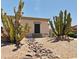 Desert landscape design using rock lined dry creek bed with native plants and cacti at 7111 S 21St Dr, Phoenix, AZ 85041