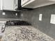 Close-up of a modern kitchen featuring granite countertops and stainless steel appliances at 7111 S 21St Dr, Phoenix, AZ 85041