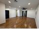 Spacious living room with wood floors, modern lighting, barn door, and neutral walls at 7111 S 21St Dr, Phoenix, AZ 85041