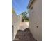 View of the outdoor shower on side of home, with rock landscaping and access to the lawn at 7111 S 21St Dr, Phoenix, AZ 85041