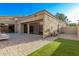 Charming backyard with a paved patio and lush synthetic grass at 7962 E San Miguel Ave, Scottsdale, AZ 85250