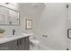Bathroom features neutral tile, quartz countertops and black hardware at 7962 E San Miguel Ave, Scottsdale, AZ 85250