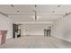 Spacious two-car garage featuring epoxy floors, bright lighting, and ample storage space at 7962 E San Miguel Ave, Scottsdale, AZ 85250