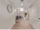 Inviting hallway featuring wood flooring, a modern mirror, and access to the living spaces at 7962 E San Miguel Ave, Scottsdale, AZ 85250