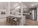 Modern kitchen with an island, bar stools, stainless steel appliances and vaulted ceilings at 7962 E San Miguel Ave, Scottsdale, AZ 85250