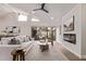 Bright living room featuring vaulted ceilings, fireplace, and sliding glass doors to the backyard at 7962 E San Miguel Ave, Scottsdale, AZ 85250