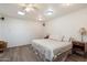 Spacious bedroom with a large bed, neutral tones, skylight, and wood-look flooring at 8042 N 28Th Ave, Phoenix, AZ 85051
