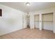 A cozy bedroom with tile flooring and closet space, offering a simple and clean aesthetic at 8042 N 28Th Ave, Phoenix, AZ 85051