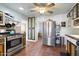 Bright kitchen featuring stainless steel appliances, rustic cabinetry, and a ceiling fan at 8042 N 28Th Ave, Phoenix, AZ 85051