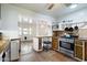 Eat-in kitchen with breakfast bar, modern appliances, a ceiling fan, and a view to the backyard at 8042 N 28Th Ave, Phoenix, AZ 85051
