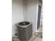 Exterior shot of an AC unit on a concrete slab against a white wall at 845 N Los Alamos Dr, Goodyear, AZ 85338