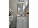 This bathroom features white cabinets, a gold mirror, and light walls at 845 N Los Alamos Dr, Goodyear, AZ 85338