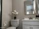 This bathroom features a white vanity and a gold mirror at 845 N Los Alamos Dr, Goodyear, AZ 85338