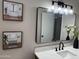Beautifully renovated bathroom with a modern vanity, stylish fixtures, and decorative wall art at 845 N Los Alamos Dr, Goodyear, AZ 85338