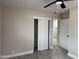 This bedroom features a sliding door closet, a ceiling fan, and gray flooring at 845 N Los Alamos Dr, Goodyear, AZ 85338