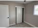 This bedroom has a window, a ceiling fan, and a sliding door closet at 845 N Los Alamos Dr, Goodyear, AZ 85338