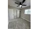 This bedroom has a ceiling fan, a window, and gray flooring at 845 N Los Alamos Dr, Goodyear, AZ 85338
