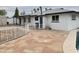 Rear exterior of home featuring white facade, patio, decorative stone, and a pool at 845 N Los Alamos Dr, Goodyear, AZ 85338