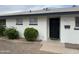 Well-kept home exterior with a black door, manicured shrubs and modern landscaping at 845 N Los Alamos Dr, Goodyear, AZ 85338
