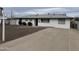 Charming single-story home with well-maintained landscaping and a spacious front yard at 845 N Los Alamos Dr, Goodyear, AZ 85338
