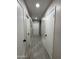 Hallway view with doors and tile flooring at 845 N Los Alamos Dr, Goodyear, AZ 85338