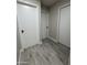 Hallway area with tile flooring and white doors at 845 N Los Alamos Dr, Goodyear, AZ 85338