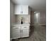 Cozy kitchen nook featuring white cabinetry and plenty of storage space at 845 N Los Alamos Dr, Goodyear, AZ 85338