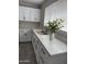 Modern kitchen showcasing white cabinetry, quartz countertops, and stainless steel appliances at 845 N Los Alamos Dr, Goodyear, AZ 85338