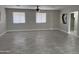 Bright living room featuring tile flooring and a contemporary ceiling fan at 845 N Los Alamos Dr, Goodyear, AZ 85338
