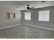Open living room featuring tile flooring, neutral paint and natural light from two windows at 845 N Los Alamos Dr, Goodyear, AZ 85338