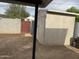 View of backyard shed with cinder block wall and a red gate at 845 N Los Alamos Dr, Goodyear, AZ 85338