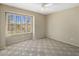 A bright bedroom with a large window and plantation shutters, neutral paint, and carpet at 9012 E Sutton Dr, Scottsdale, AZ 85260