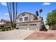 Two-story home with a three-car garage, well-maintained landscaping, and mature palm trees at 9012 E Sutton Dr, Scottsdale, AZ 85260