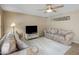Cozy living room with plush sofas, a ceiling fan, and neutral-toned decor at 9012 E Sutton Dr, Scottsdale, AZ 85260