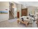 Spacious living room featuring tile floors, a staircase, and comfortable seating at 9012 E Sutton Dr, Scottsdale, AZ 85260