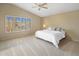 Serene main bedroom with a ceiling fan, neutral colors, and a large window with shutters at 9012 E Sutton Dr, Scottsdale, AZ 85260