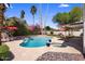 A beautiful pool and spa surrounded by lush landscaping and red umbrellas at 9012 E Sutton Dr, Scottsdale, AZ 85260