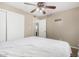 Comfortable bedroom featuring a ceiling fan, neutral walls, and a closet for ample storage at 9028 W Osborn Rd, Phoenix, AZ 85037