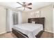 Comfortable bedroom with carpet, a ceiling fan, and sheer curtains at 9028 W Osborn Rd, Phoenix, AZ 85037